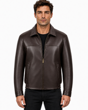 Charger l'image dans la galerie, A man wearing a dark brown leather jacket over a black shirt and black pants, standing against a plain white background.

