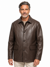 Cargar imagen en el visor de la galería, A man wearing a dark brown leather jacket with a button-up front and flap pockets, paired with light beige pants, against a plain white background.
