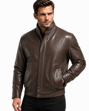 Load image into Gallery viewer, A man wearing a dark brown leather jacket with a stand-up collar and front zipper, paired with black pants, photographed against a plain white background.
