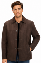 Charger l'image dans la galerie, A man wearing a dark brown suede-like button-up jacket over a black shirt and blue jeans, photographed against a plain white studio background.
