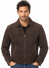 Charger l'image dans la galerie, A man wearing a dark brown suede zip-up jacket over a black shirt and blue jeans, photographed against a plain white background.
