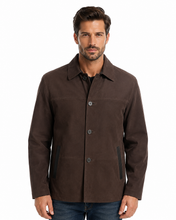 Charger l'image dans la galerie, A man wearing a dark brown utility-style jacket over a black shirt and blue jeans, photographed against a plain white studio background.
