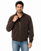 Load image into Gallery viewer, A man wearing a dark brown zip-up fleece jacket and blue jeans, standing against a solid white background.
