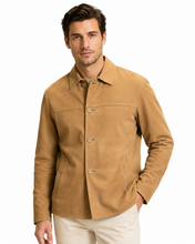Charger l'image dans la galerie, A man wearing a tan suede jacket and light beige pants, standing against a plain white background.
