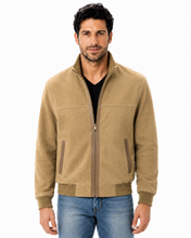Load image into Gallery viewer, A man wearing a tan zip-up suede jacket over a black shirt and blue jeans, photographed against a plain white background.
