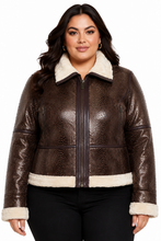 Cargar imagen en el visor de la galería, A woman modeling a brown textured real-croc shearling jacket with a cream-colored collar, zipper trim, and cuffs, paired with black pants against a white background.
