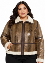 Cargar imagen en el visor de la galería, A woman modeling a metallic bronze reptile-print jacket with a cream sherpa collar, front zipper, and dark brown trim, paired with black pants against a plain white background.
