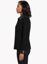 Charger l'image dans la galerie, A woman shown in profile wearing a black long-sleeve jacket with contrasting black leather trim on the collar and cuffs, paired with black pants, against a plain white background.
