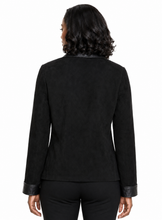 Charger l'image dans la galerie, A woman viewed from the back wearing a black long-sleeve jacket with contrasting black leather trim at the collar, cuffs, and hem, paired with black pants against a plain white background.

