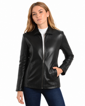 Cargar imagen en el visor de la galería, A woman wearing a black real leather jacket over a white top and dark blue jeans
