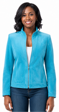 Cargar imagen en el visor de la galería, A woman wearing a bright turquoise blue suede jacket over a white top and dark blue jeans, photographed against a plain white background.
