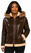 Charger l'image dans la galerie, A woman wearing a brown real-croc leather aviator jacket with a beige sherpa lining and faux-fur trimmed hood, photographed against a solid white background.
