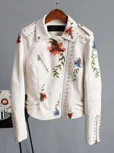 Cargar imagen en el visor de la galería, Floral Print Faux Leather Jacket with studded details, featuring vibrant flower embroidery on white faux leather.

