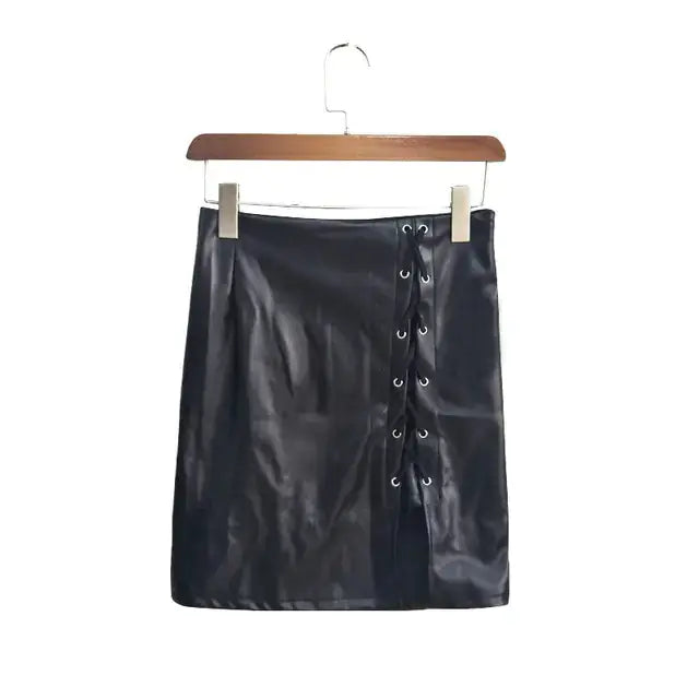 Belted vegan leather high-slit skirt with edgy lace-up design, hanging on wooden hanger. Stylish and bold fashion statement.