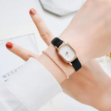 Load image into Gallery viewer, Woman&#39;s wrist wearing Oval Dial Retro Watch with vintage design and black strap, adding timeless elegance to any outfit.
