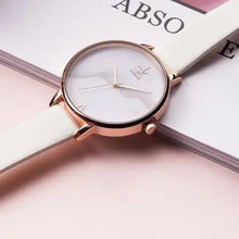 Load image into Gallery viewer, Elegant women&#39;s fashion watch with a white strap and rose gold accents on a pink background. Perfect for elevating style and elegance.
