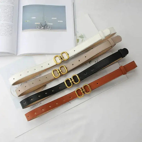 Elegant leather designer belts for women in white, beige, black, and brown with gold buckles, showcasing sophistication and style.