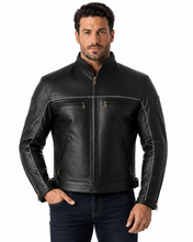 Charger l'image dans la galerie, Black vented leather motorcycle jacket with light reflector, worn by a model. Features air vents and adjustable straps for comfort and safety.
