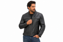 Charger l'image dans la galerie, Black vented leather motorcycle jacket with light reflector, worn by a model.
