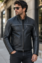 Charger l'image dans la galerie, Black vented leather motorcycle jacket with light reflector, worn by a model.
