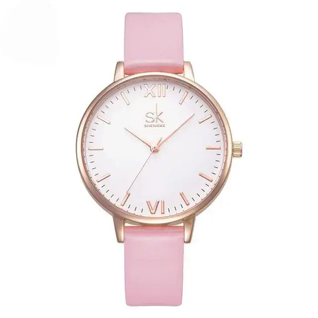 Luxury pink leather-strap watch with gold case, featuring a minimalist white dial and Roman numerals, exemplifying elegance and style.
