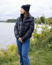 Charger l&#39;image dans la galerie, Woman wearing CS101 HAAKWEAR Traditional Silent Cuffed Beanie, Midnight Black by the lake.
