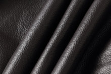 Charger l'image dans la galerie, Close-up of dark brown pebbled leather fabric with soft diagonal folds showing texture and sheen.
