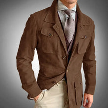 Load image into Gallery viewer, Man wearing a premium brown suede jacket with buttoned pockets, showcasing refined style and craftsmanship.
