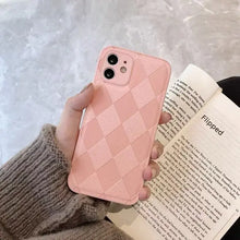 Cargar imagen en el visor de la galería, Person holds pink checkered phone case while reading a book, featuring a cozy knit sweater
