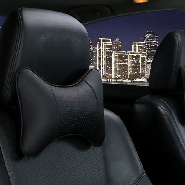 PU leather car neck pillow on seat, night city backdrop, offers head pain relief and comfort. Stylish vegan leather, imported quality.