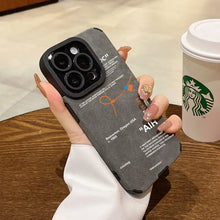 Load image into Gallery viewer, Luxury leather sneaker phone case with sleek design held next to a coffee cup on a wooden table.
