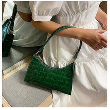 Load image into Gallery viewer, Green crocodile pattern PU leather women&#39;s shoulder bag with smooth zipper, ideal for various occasions, held by a woman in a white dress.
