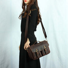 Load image into Gallery viewer, Woman carrying The Faust Leather Camera Bag | Crossbody Vintage Camera Messenger Bag, handcrafted from full-grain leather.
