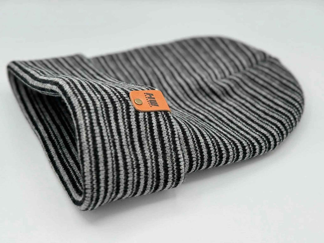 HAAKWEAR Traditional Contrast Cuffed Beanie/ Hat - Black / Gray, Made in USA, shown folded with striped pattern and logo.