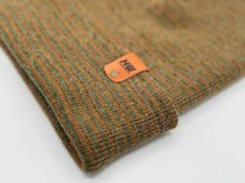 Load image into Gallery viewer, Close-up of HAAKWEAR Traditional Contrast Cuffed Beanie Hat - Brown / Green, Made in USA, showcasing knit texture and leather tag detail.
