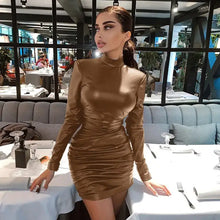 Load image into Gallery viewer, Woman wearing a vintage leather dress with high neck design, exuding elegance and sophistication in a chic restaurant setting.
