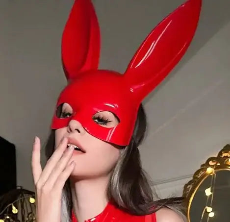 Woman wearing a red leather mask with tall ears, part of a sheer leather jacket set. Available in black and red. Perfect for unique fashion styles.