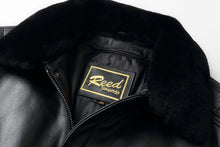 Load image into Gallery viewer, Close-up of REED Men&#39;s Premium Leather Aviator Bomber Jacket&#39;s collar and label, showcasing its durable imported leather construction.
