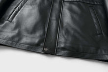 Load image into Gallery viewer, Close-up of REED 34&#39;&#39; Raglan Car Coat in black lamb leather with zip-out lining, featuring sleek design and soft durable touch.
