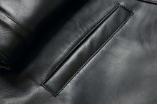 Load image into Gallery viewer, Close-up of a black leather pocket on a 34&#39;&#39; Raglan Reed Classic Men&#39;s Car Coat in Imported Lamb with a luxurious, soft texture.
