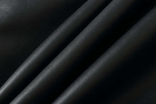 Load image into Gallery viewer, Close-up of black lamb leather texture, showcasing elegant grain and softness for luxury clothing and accessories.
