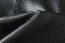 Load image into Gallery viewer, Close-up of black lamb leather fabric for REED men&#39;s car coat with soft, durable texture.
