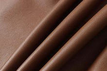 Load image into Gallery viewer, Close-up of brown lambskin leather fabric texture, highlighting its soft and durable qualities ideal for premium jackets.
