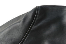 Load image into Gallery viewer, Close-up of black genuine lambskin leather from REED EST. 1950 Men&#39;s Jacket, showcasing premium craftsmanship and soft texture.
