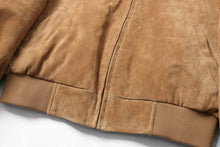 Load image into Gallery viewer, Close-up of REED men&#39;s suede leather baseball jacket, showcasing soft brown fabric, ribbed cuffs, and classic design.

