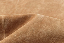 Load image into Gallery viewer, Close-up of soft suede leather texture in light brown, showcasing the fabric’s smooth and plush quality.
