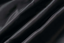 Load image into Gallery viewer, Close-up of soft, supple black satin lining fabric texture.
