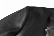 Load image into Gallery viewer, Close-up of REED Men&#39;s Premium Lambskin Leather Blazer showcasing soft-touch durable black leather.
