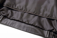 Load image into Gallery viewer, Close-up of REED Men&#39;s black New Zealand lambskin leather jacket showing soft interior lining.
