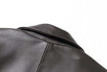 Load image into Gallery viewer, Close-up of black lambskin leather jacket collar by REED, highlighting smooth texture and quality craftsmanship.
